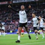 Alex Iwobi celebrates after scoring against Manchester United at Old Trafford.