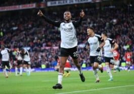Alex Iwobi celebrates after scoring against Manchester United at Old Trafford.